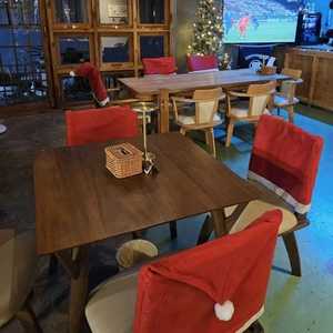 Red Christmas hat dining chair cover with white plush pompom for holiday home decoration