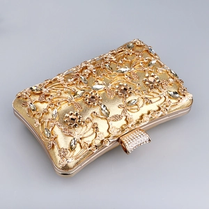 Close-up of gold floral hollow evening bag with sparkling rhinestone encrusted clasp