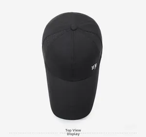 Top view of black quick-dry baseball cap featuring breathable laser-cut holes and embroidery