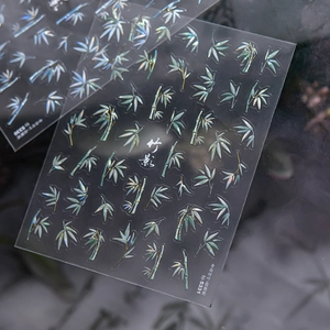 Detail of iridescent bamboo nail stickers with shell luster and minimalist leaf patterns