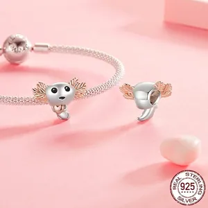 Polished S925 sterling silver axolotl charm with rose gold details on a mesh bracelet
