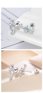 Macro detail of silver seahorse stud earring with blue zircons and screw back closure