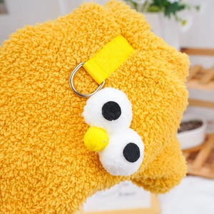 Yellow plush pet outfit featuring Sesame Street-style Big Bird eyes and nose details