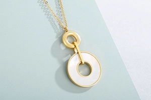 Detailed shot of interlocking gold circles with white mother-of-pearl inlay pendant