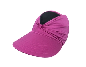 Detail of rose pink sun visor with wide brim and pleated fabric texture on white background
