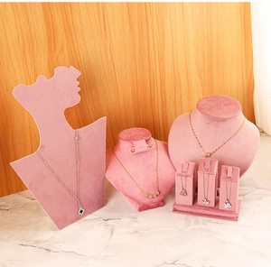 Detailed set of pink velvet jewelry display stands on elegant marble surface