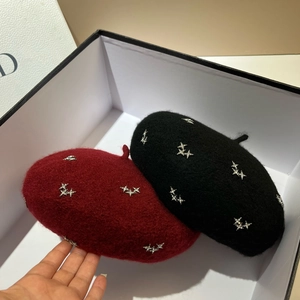 Detailed view of red and black rhinestone star wool berets inside a gift box