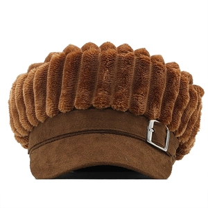 Close-up of brown corduroy newsboy cap with side silver metal buckle detail