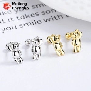 Detail of 3D teddy bear screw back earrings in polished silver and gold finishes