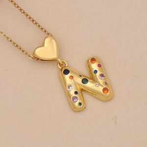Detail of gold letter N pendant with colorful zircon stones and heart-shaped bail