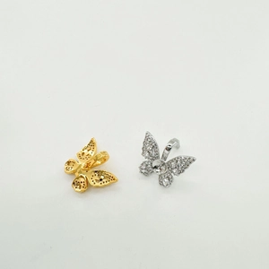 Detail of gold and silver butterfly pendants with zircons for DIY jewelry making