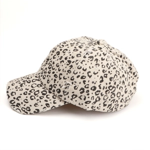 Detail of distressed brim on a vintage leopard print baseball cap with frayed canvas texture