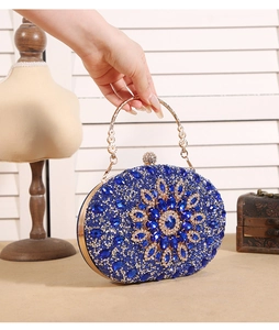 Detailed shot of luxury blue sunflower evening bag with crystals and gold handle