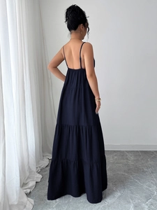 Detail view of navy blue tiered maxi dress showing the elegant back and strap design