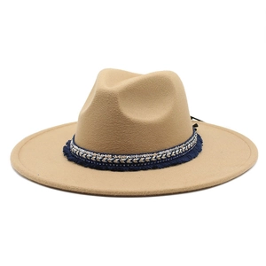 Detail of camel wool felt fedora with ethnic style blue tassel and silver sequin band