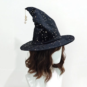 Detail of black witch hat with gold star prints and metallic star pendant decoration