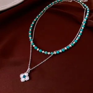 Vintage double layer necklace with turquoise beads and zircon clover pendant on red silk