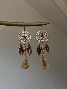 Détails des boucles d'oreilles bohèmes avec breloques feuilles et pompons marron