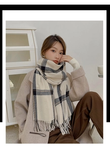 Detailed view of beige cashmere feel scarf with brown check patterns and fringe edges