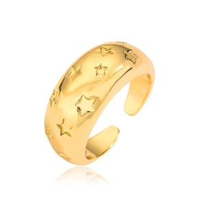 Close-up of golden adjustable ring featuring engraved star patterns and polished finish