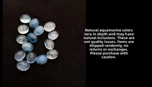 Close-up of oval aquamarine stones with natural icy cracks and light blue hues