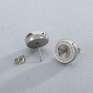 Detailed view of round silver stud earrings with sparkling cubic zirconia micro-pave