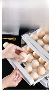 Detail of drawer-style stackable egg storage box showing the sliding layer and egg slots