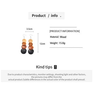 Detail of bohemian wood bead drop earrings showing 12cm length and material specs