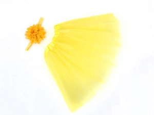 Detailed flat lay of yellow chiffon tutu skirt and matching floral headband set for babies