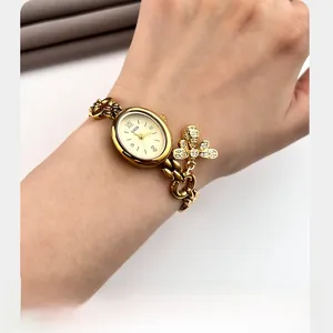 Detailed view of GEDI gold oval watch with crystal bee charm and elegant chain strap