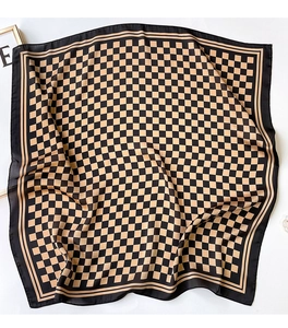 Detail view of checkers pattern silk scarf with smooth texture and soft folds