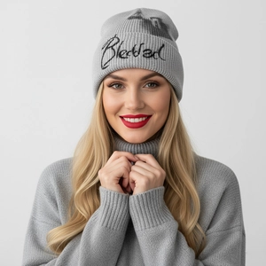 Close-up of black Blessed embroidery on grey knit slouchy beanie hat for street style