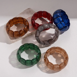 Set of six irregular geometric resin bracelets with sparkly glitter and elastic cord