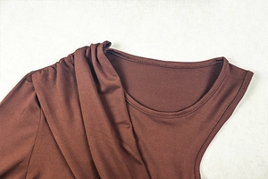 Detail of ruched shoulder and smooth fabric on a brown solid color bodycon dress