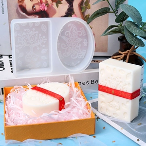 Dual-cavity silicone soap mold with floral patterns and a finished Christmas soap bar
