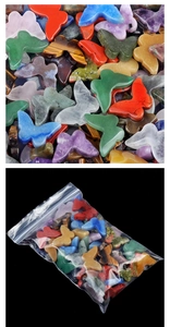 Close-up of polished butterfly-shaped natural crystal stones in various colors for decor