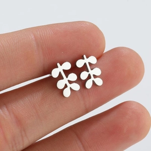 Polished silver leaf stud earrings in a minimalist nature-inspired geometric design