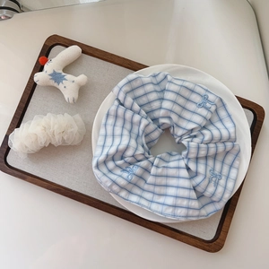 Blue plaid scrunchie set with bow embroidery and white mesh on a wooden tray
