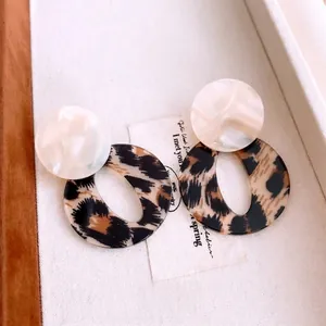 Vintage acrylic leopard print hoop earrings with marble texture on jewelry box display