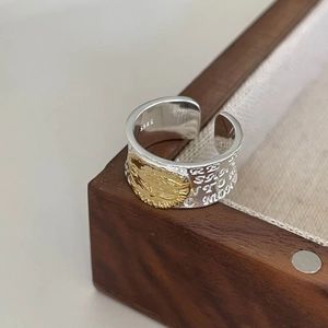 Vintage 925 sterling silver open ring with gold Mary relief on a wooden box