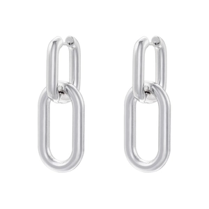 Close-up of interlocking silver geometric link earrings with a high-polished finish