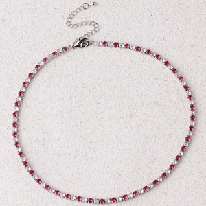 Detail of silver tennis necklace with red and white stones and lobster clasp