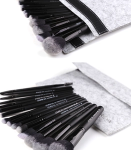 Detail of 15-piece black makeup brush set with gradient bristles and grey felt pouch