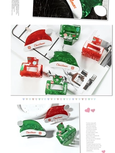 Close-up of festive Christmas hat and gift box hair claws in red and green resin