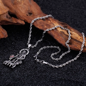 Detailed shot of Monkey King pendant in vintage silver with red gems on twisted rope chain