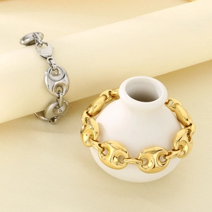 Detailed view of coffee bean link bracelets in gold and silver on decorative vases