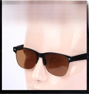 Close-up of semi-rimless sunglasses featuring brown lenses and metal rivet accents