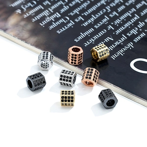 Detailed view of hexagonal micro-pave cylinder spacers in gold, silver, and rose gold