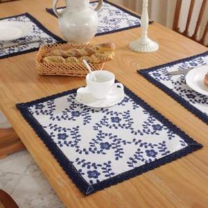 Retro blue floral cotton linen placemat with crochet lace border on wooden table