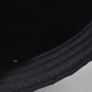 Macro detail of the reinforced stitching and durable fabric on the black cap brim